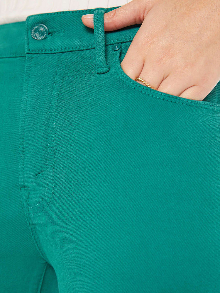 Close up swatch view of a teal pant.