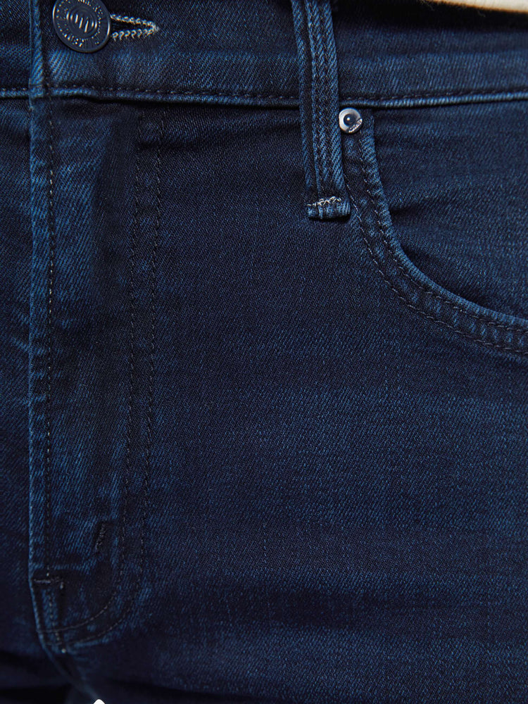 Swatch view of a woman in dark denim mid-rise jeans with a wide straight leg, zip fly and clean ankle-length inseam.