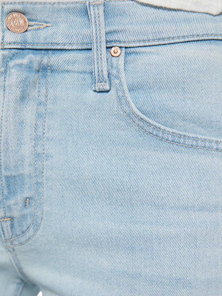 Swatch view of a woman in a light blue mid-rise jeans with a wide straight leg, zip fly and clean ankle-length inseam. 
