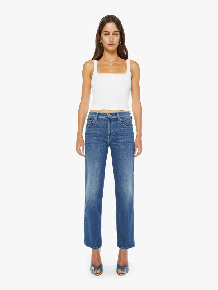 Front view of a mid blue mid-rise jeans with a wide straight leg, zip fly and clean ankle-length inseam.