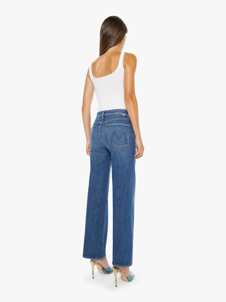 Back view of a mid blue mid-rise jeans with a wide straight leg, zip fly and clean ankle-length inseam.