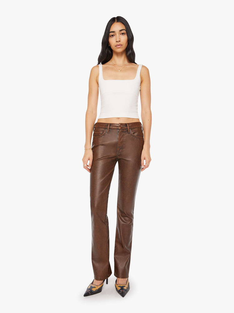 Front view of a woman in a faux dark chocolate brown high waisted bootcut with a 32-inch inseam and a clean hem.