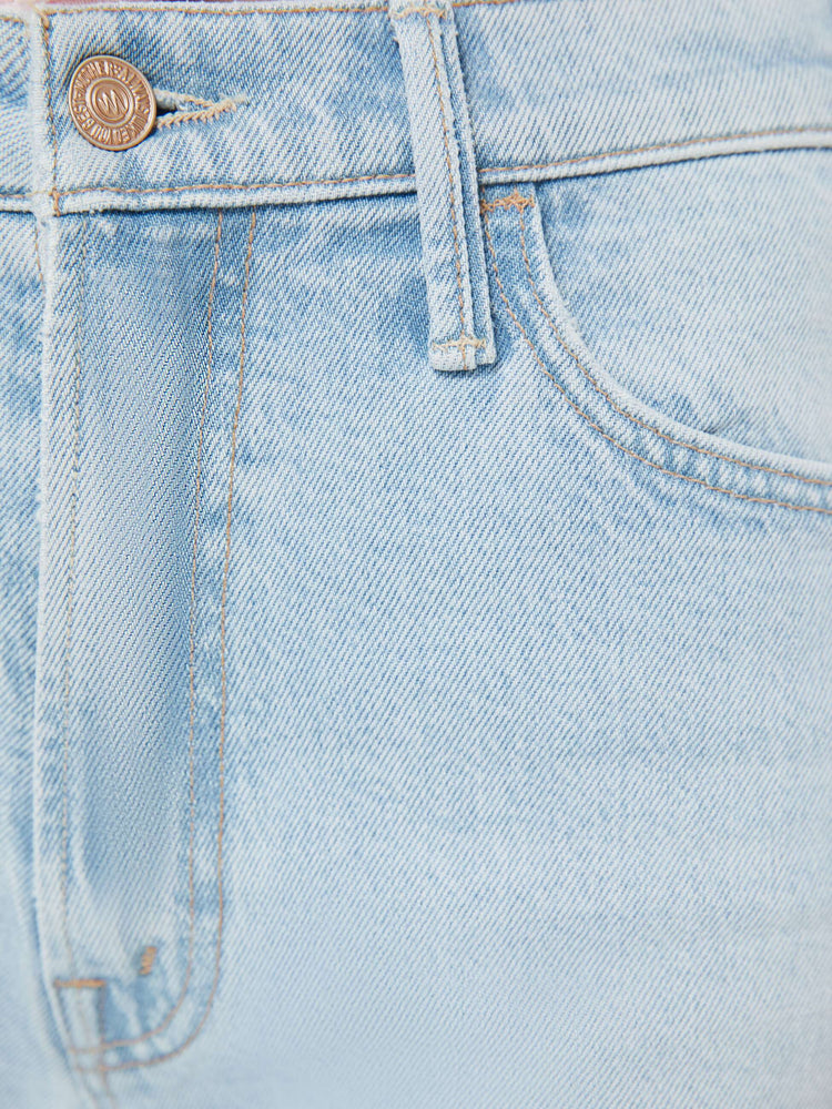 Swatch view of a woman in a light blue wide leg jeans with a zip fly, high rise, 31-inch inseam and a frayed hem. 