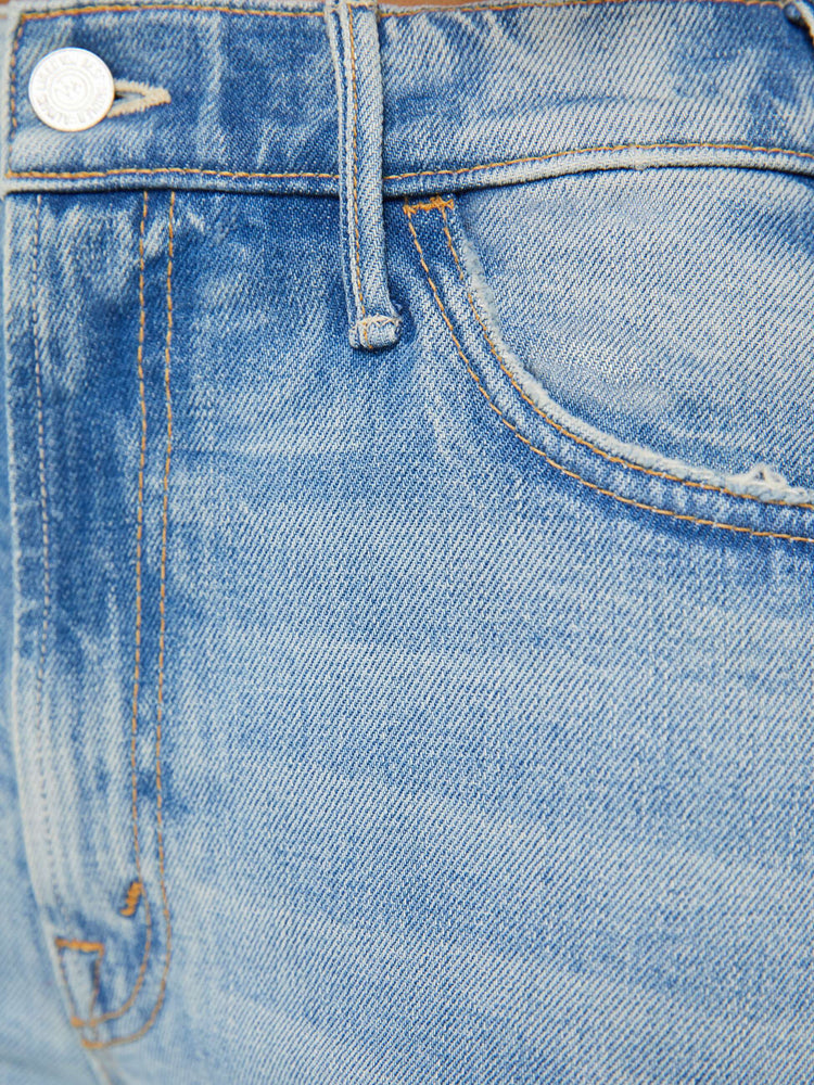 Detailed view of a high-rise light blue wide leg with whiskering, fading, and distressed details.