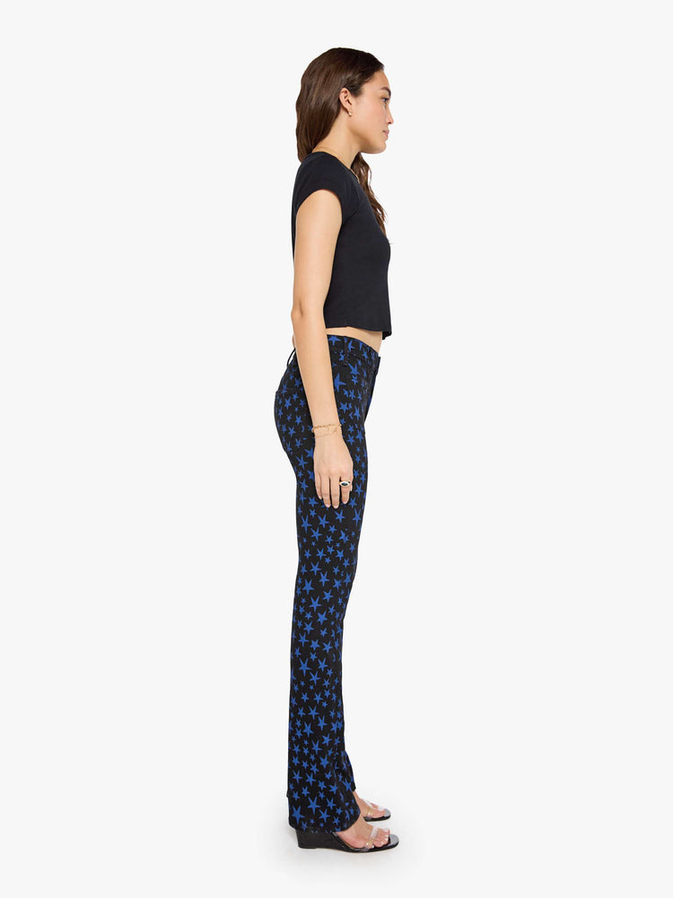 Side view of a woman in true black and navy stars  high-waisted bootcut has a zip fly, patch pockets, a 32-inch inseam and a clean hem. 
