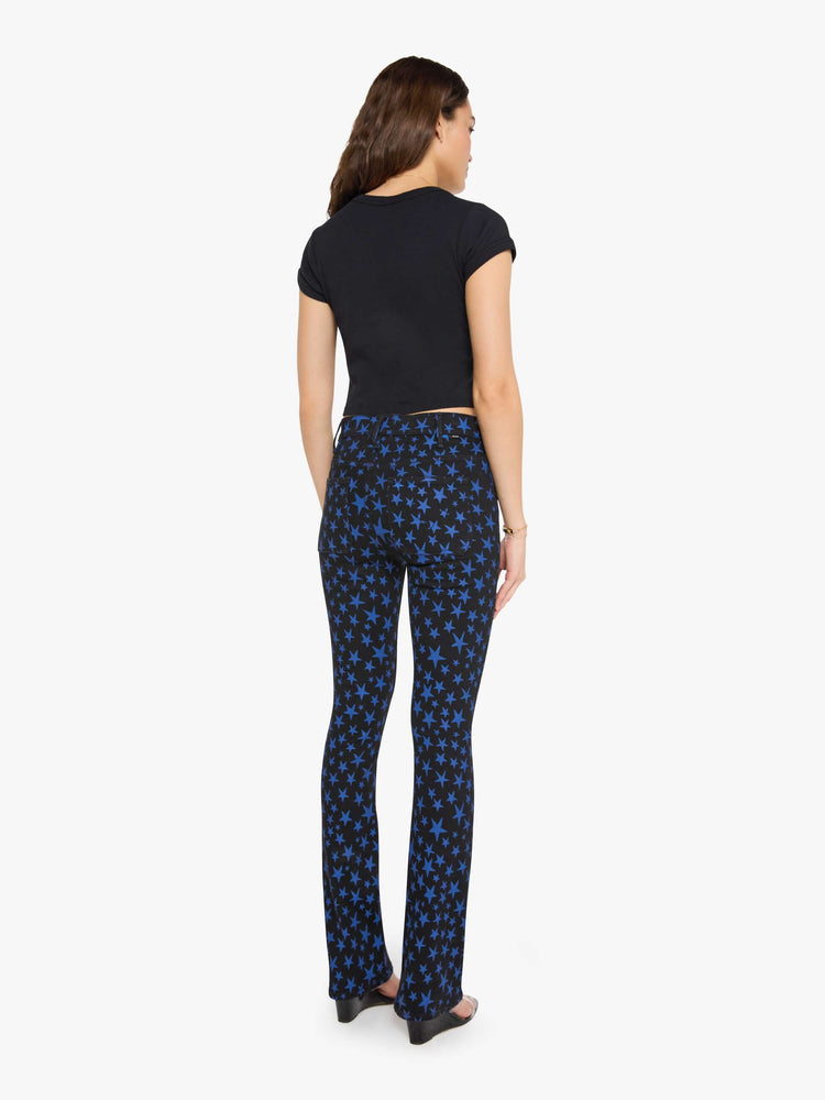 Back view of a woman in true black and navy stars  high-waisted bootcut has a zip fly, patch pockets, a 32-inch inseam and a clean hem. 