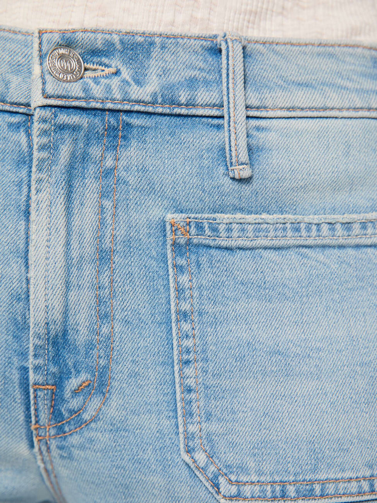 Swatch view of a woman in a light blue high-waisted bootcut has a zip fly, patch pockets, a 32-inch inseam and a clean hem.