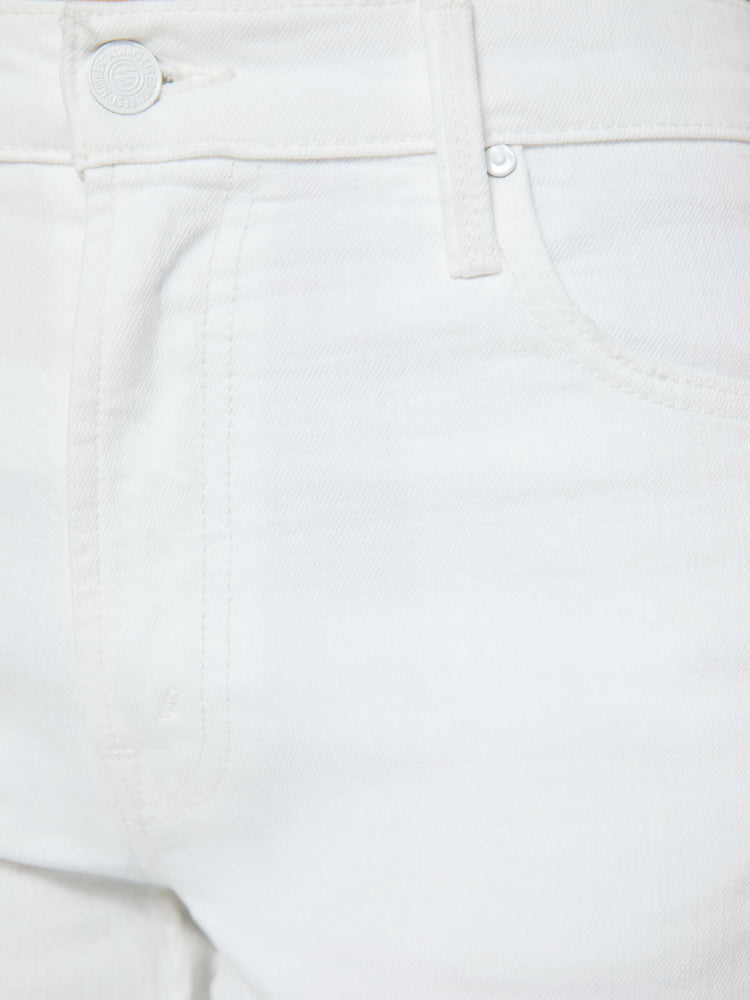 Swatch view of a woman in a white high-waisted jeans with a loose wide leg and a long 32-inch inseam with a clean hem.
