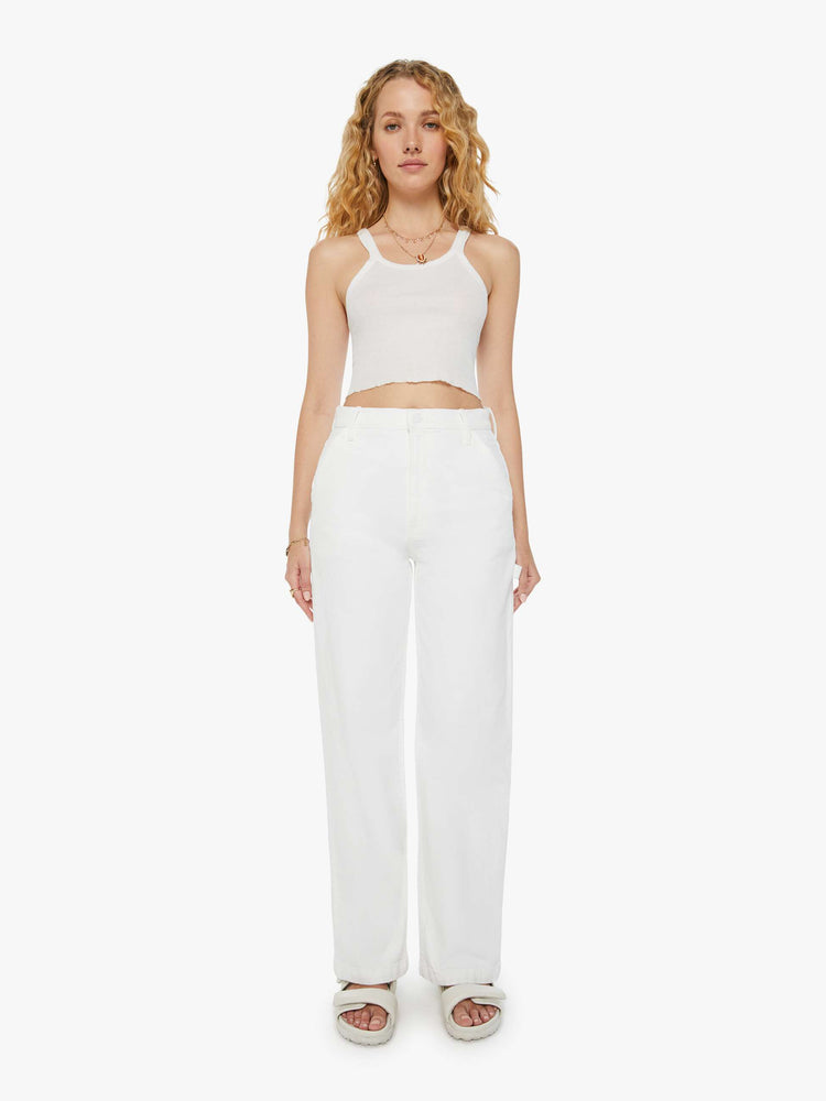 Front view of a woman in white super high-waisted jeans with utility-inspired patch pockets.