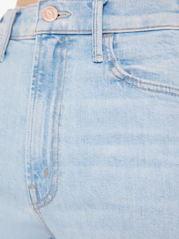 Close up swatch view of a light blue wash jean.