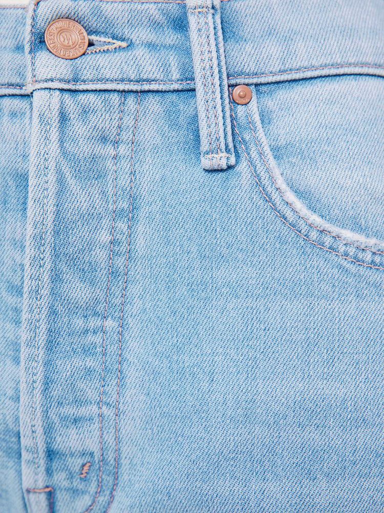 Swatch view of a woman in a light blue  high-rise flare with a button fly, 28.25-inch inseam and a frayed hem. 