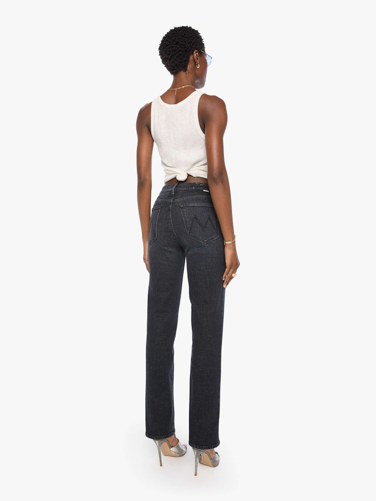 Back view of a woman in a washed black high-rise jeans with a straight leg, zip fly and a 32-inch inseam with a clean hem.