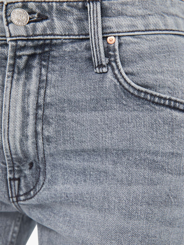 Swatch view of a woman in light-grey high-waisted wide bootcut jeans designed to sit lower on the waist with whiskering and fading