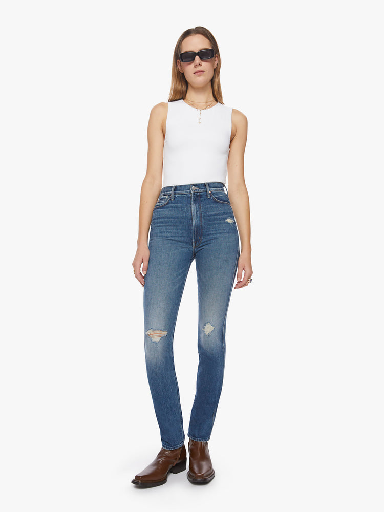 Front view of a woman high-rise slim-straight leg has a long 34-inch inseam with a clean hem in a dark blue wash.