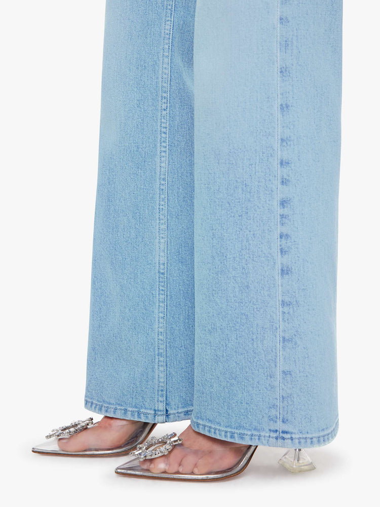 Close up view of a woman in a light blue  jean with a high-rise bootcut with a zip fly, looser leg and a long 32-inch inseam with a clean hem. 