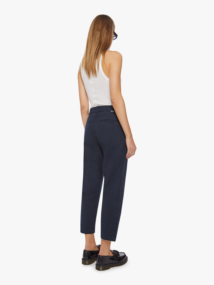 Back view of a woman navy trouser borrowed from MOTHER's men's collection with a high rise, tapered leg, slash pockets and an ankle-length inseam.