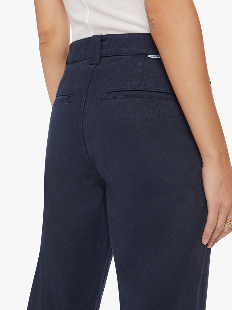 Close up back view view of a woman navy trouser borrowed from MOTHER's men's collection with a high rise, tapered leg, slash pockets and an ankle-length inseam.