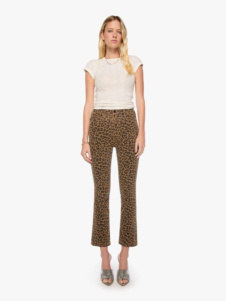 Front view of a woman in cheetah print high-rise flare has a zip fly, 28.25-inch inseam and a clean hem.
