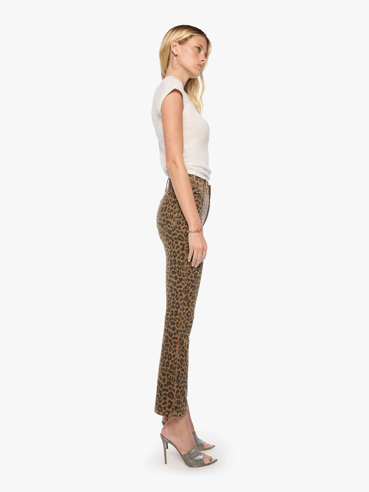 Side view of a woman in cheetah print high-rise flare has a zip fly, 28.25-inch inseam and a clean hem.