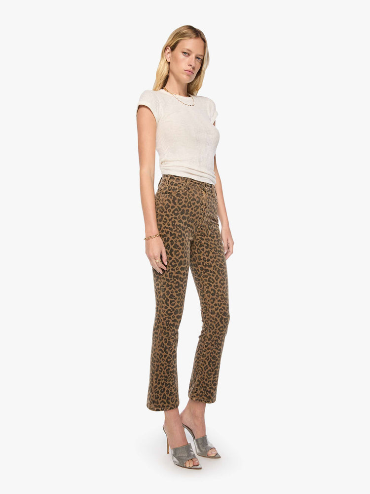 Front view of a woman in cheetah print high-rise flare has a zip fly, 28.25-inch inseam and a clean hem.