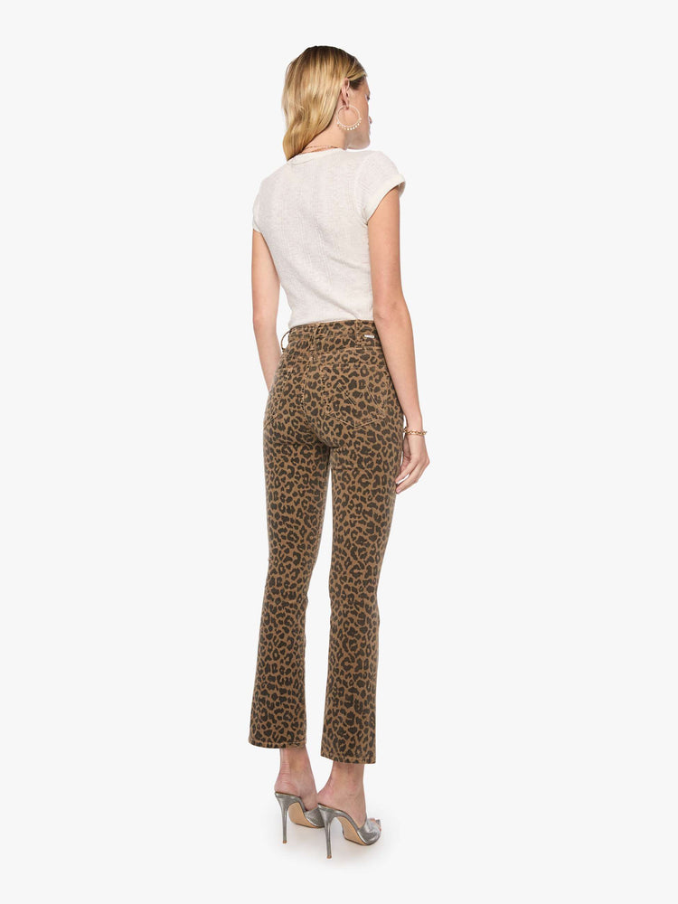 Back view of a woman in cheetah print high-rise flare has a zip fly, 28.25-inch inseam and a clean hem.