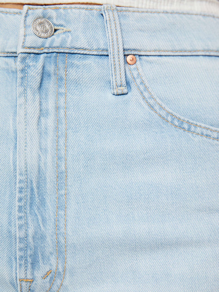 Swatch view of a woman in a light blue wide-leg jeans feature a high rise with a slightly dropped crotch, zip fly, low-set back pockets and a 31-inch inseam.