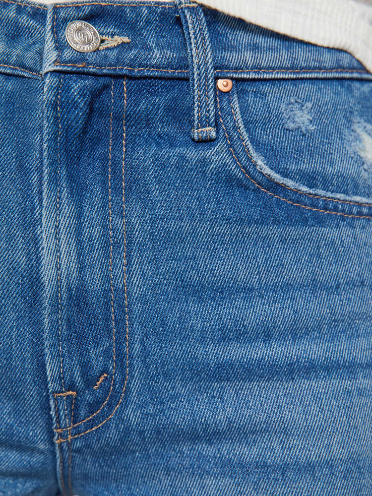 Swatch view of a woman in a med blue wide-leg jeans feature a high rise with a slightly dropped crotch, zip fly, low-set back pockets and a 32 1/4-inch inseam with a clean hem.