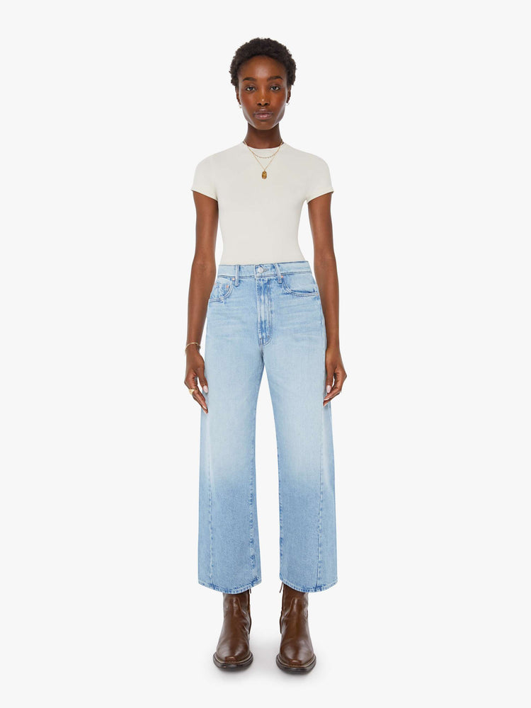 Front view of a woman super high-waisted jean with a wide, curved leg, an ankle-length inseam and a clean hem in a light blue wash.