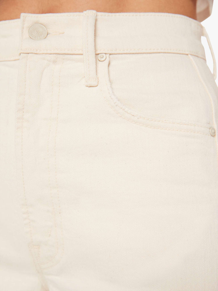Swatch view of a woman in a cream white pant with super high-waisted jean with a wide, curved leg, an ankle-length inseam and a clean hem.