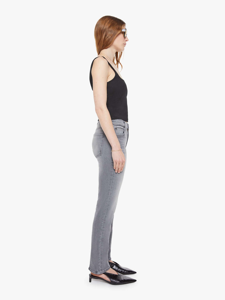 Side view of a woman in a light grey mid-rise straight leg with a zip fly, 29-inch inseam and a clean hem.