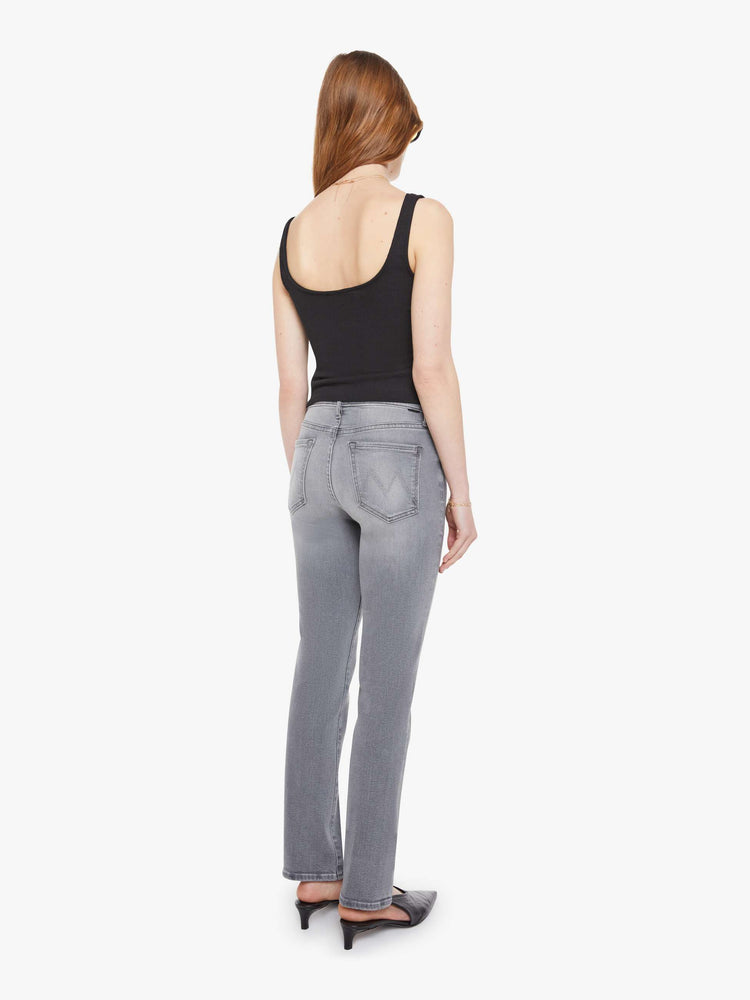 Back view of a woman in a light grey mid-rise straight leg with a zip fly, 29-inch inseam and a clean hem.
