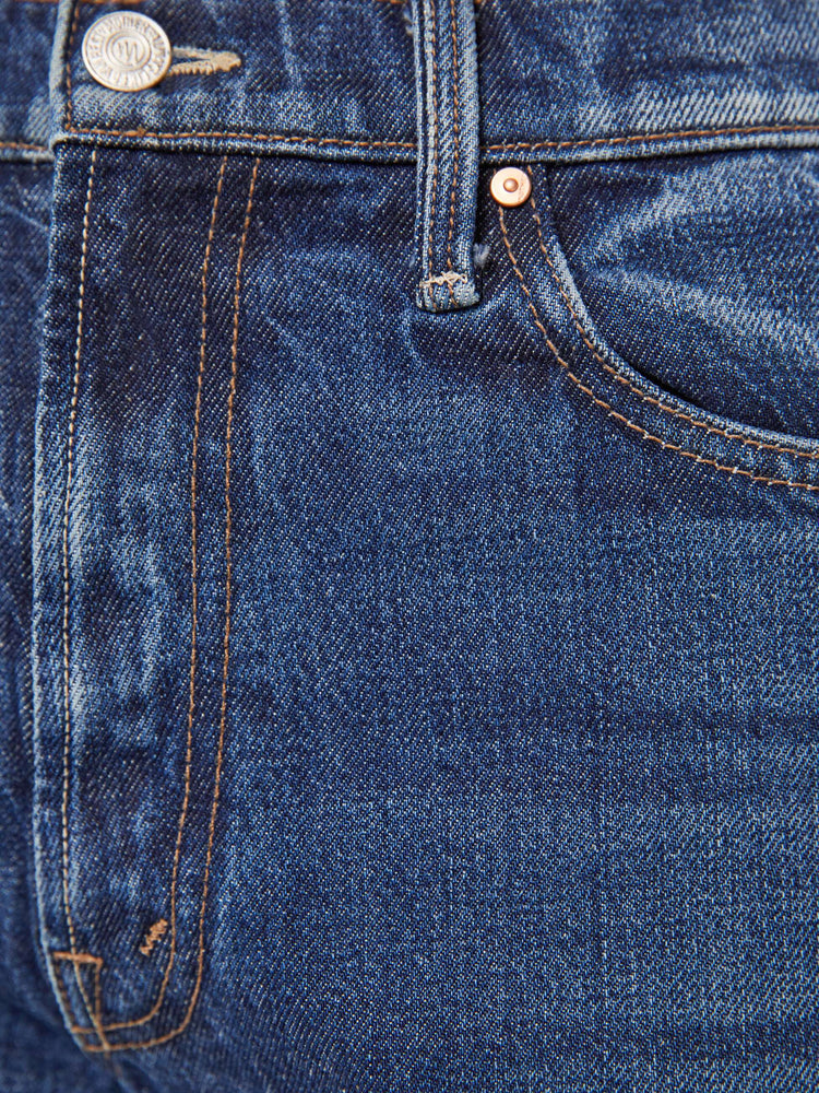 Swatch view of a woman in dark blue high-waisted jeans with a wide straight leg, zip fly, long 34-inch inseam and a clean hem.
