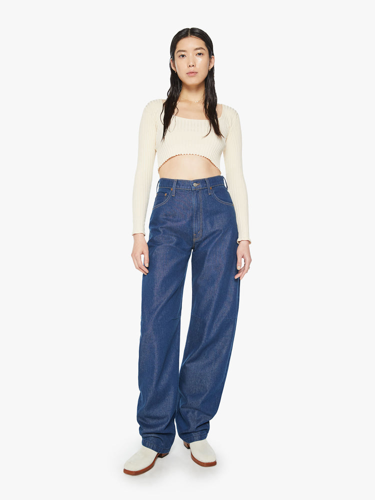 Front view of a woman super high-rise jeans are designed with loose fit and a tapered leg with a long 34-inch inseam that stacks at the ankle in a dark blue wash.