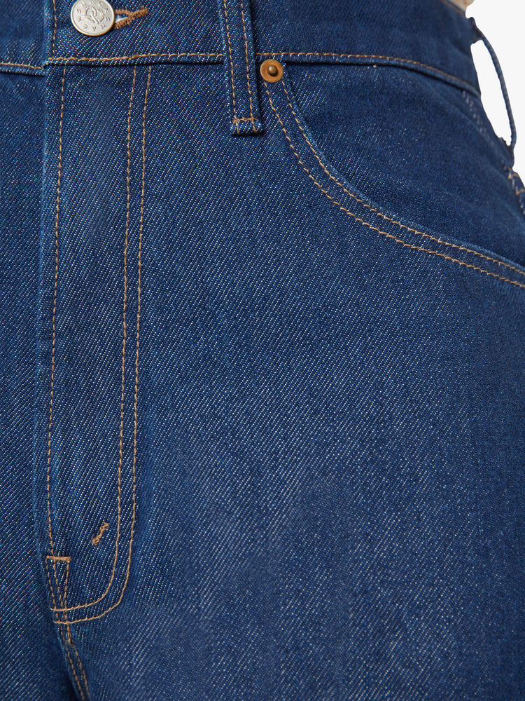 Swatch view of a woman super high-rise jeans are designed with loose fit and a tapered leg with a long 34-inch inseam that stacks at the ankle in a dark blue wash.