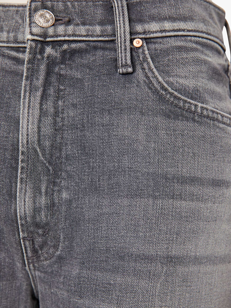 Swatch view of a woman in grey washed jeans designed to sit lower on the hips with a zip fly, loose wide leg and a 31-inch inseam with a cuffed hem.