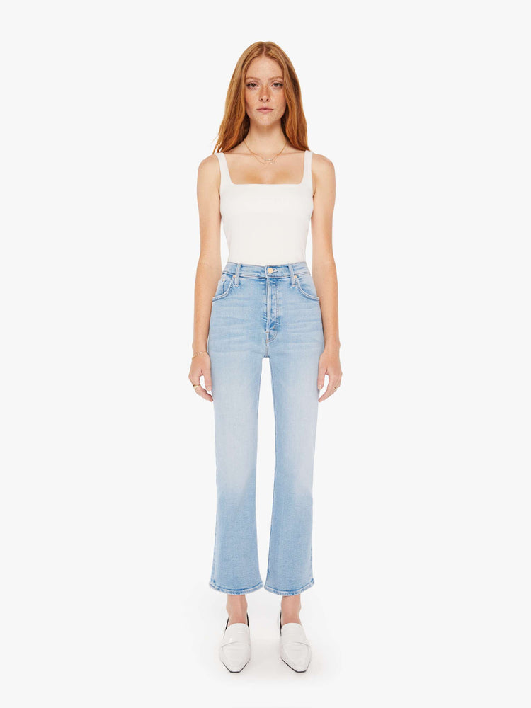 Front view of a woman high-rise flare with a button fly and 28.25-inch inseam with a clean hem in a light blue wash.