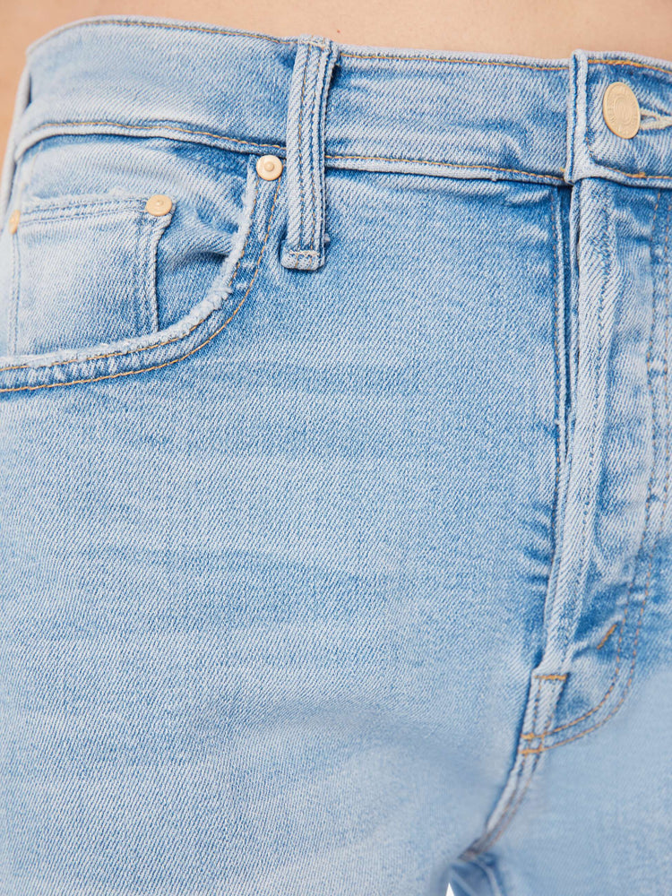 Swatch view of a woman high-rise flare with a button fly and 28.25-inch inseam with a clean hem in a light blue wash.
