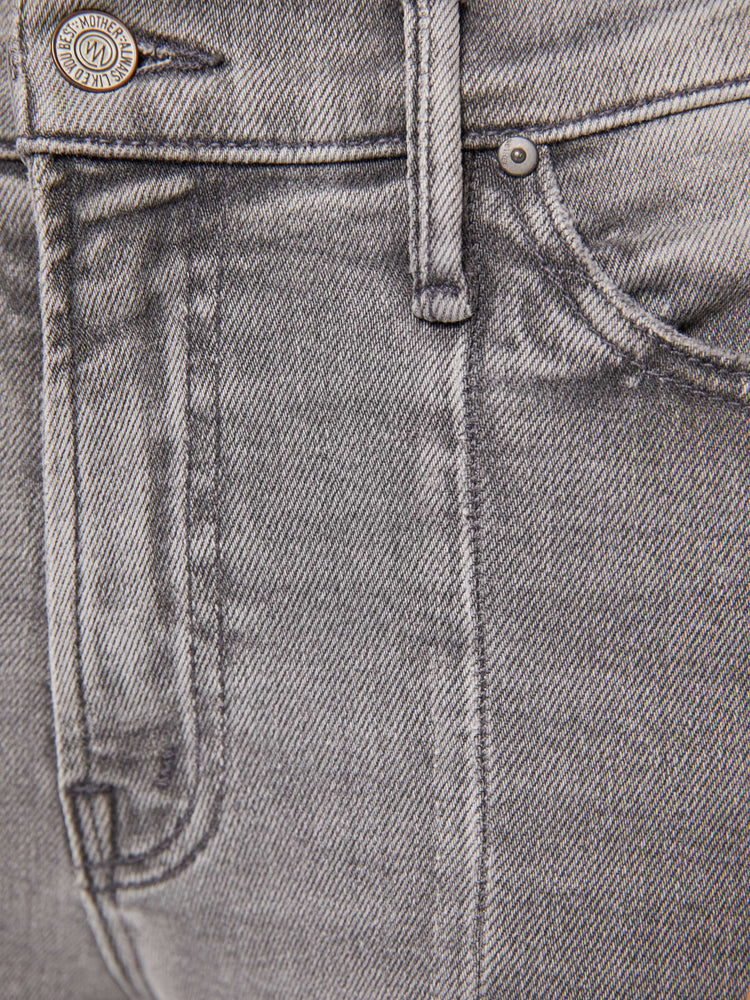 Swatch view of a woman in a light grey  high-waisted bootcut features seamed details down the front, a zip fly, ankle-length inseam and a frayed triple step-hem. 