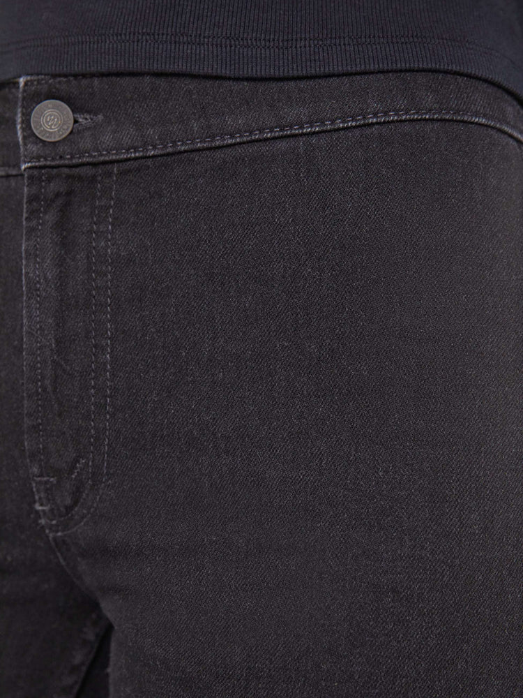 Swatch view of a woman in a black straight-leg jeans with a mid rise, zip fly, ankle-length inseam and a clean hem.