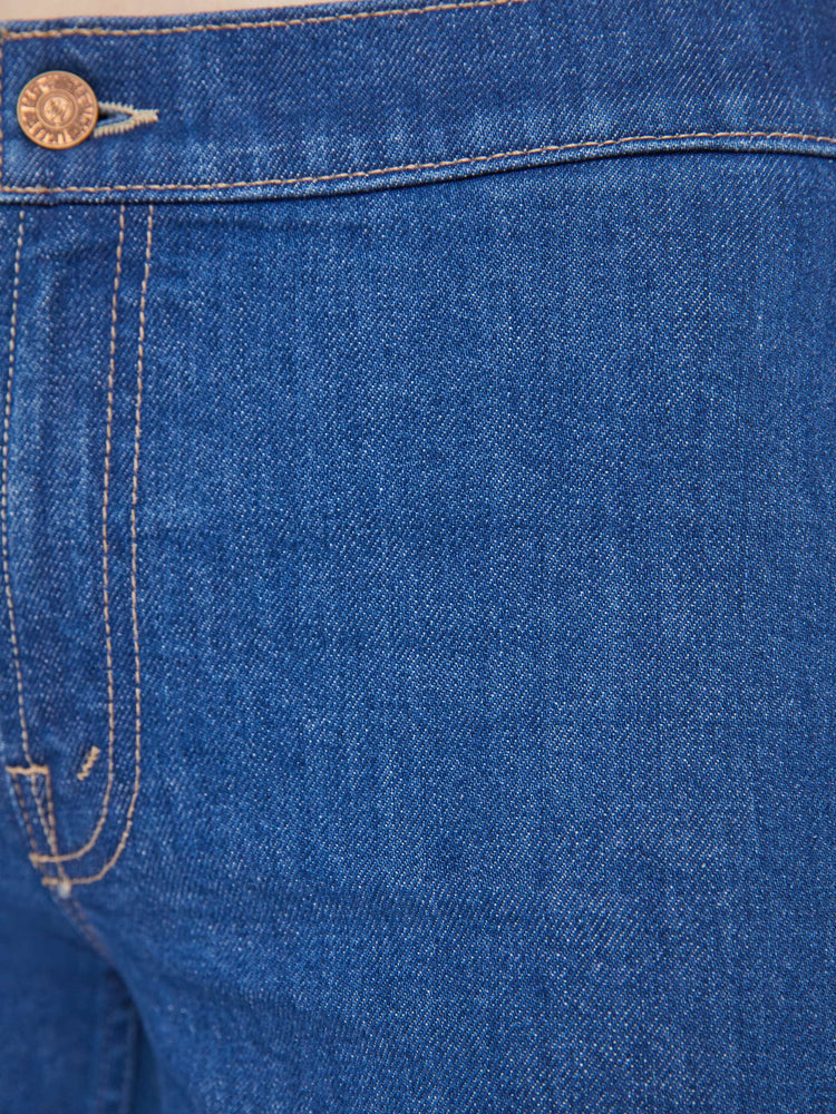 Swatch  view of a woman in a mid blue straight-leg jeans with a mid rise, zip fly, ankle-length inseam and a clean hem.