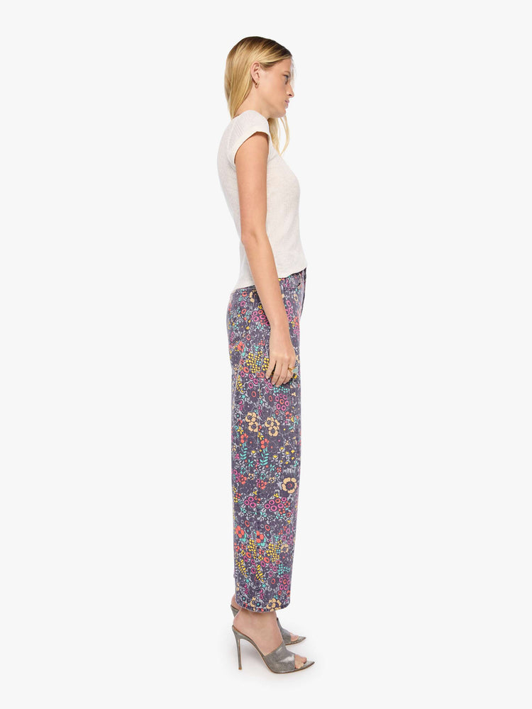Side view of a woman in floral print super high-waisted pant with a wide, curved leg, zip fly, 28.25-inch inseam and a clean hem.