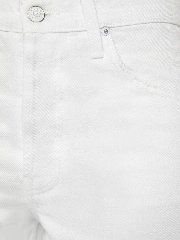 Swatch view of a woman in off-white mid-rise jeans designed with a button fly, slouchy, loose fit  with a chewed hem, tears at the knees and thigh, finished with a pretzel-detailed button.