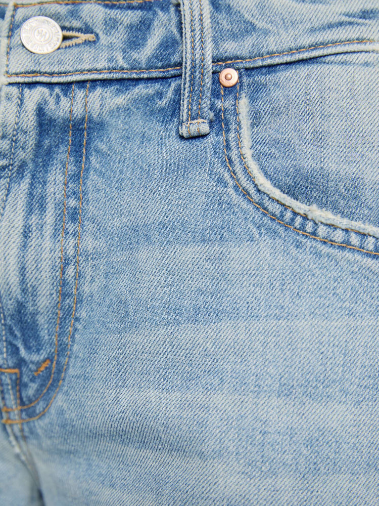 Swatch view of a woman  in a light blue mid-rise jeans with a wide straight leg, zip fly and long 32-inch inseam with a clean hem.