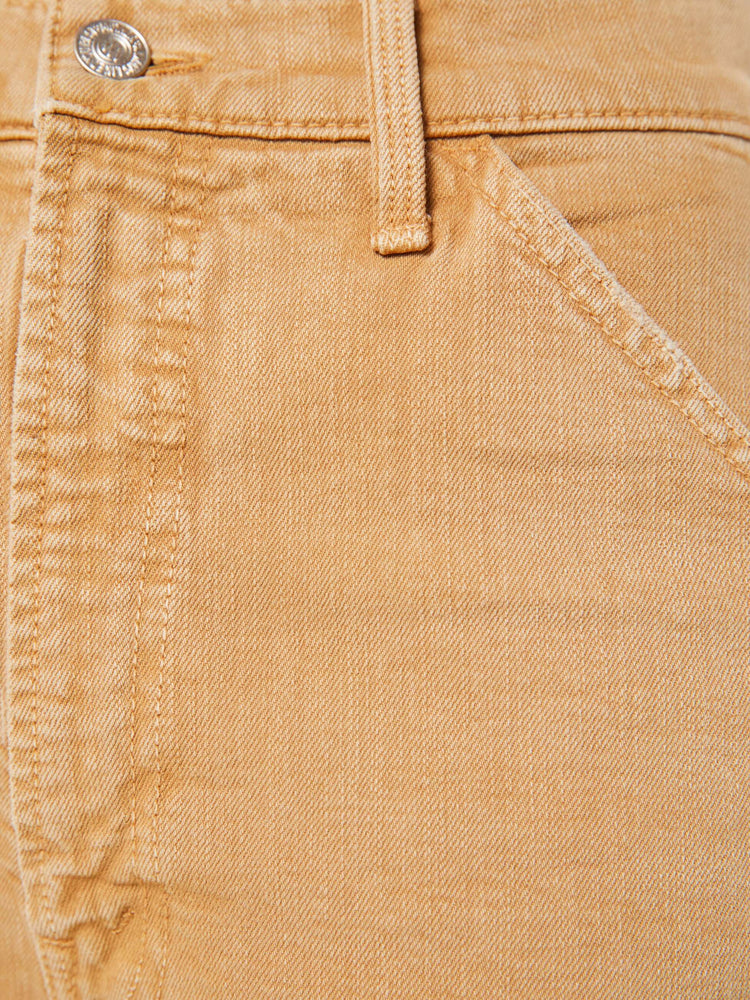 Swatch view of a woman in a faded khaki super high-waisted pants with a wide leg, zip fly, oversized patches at the knees, a long 32-inch inseam and a clean hem.