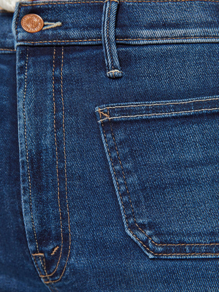 Swatch view of a woman in a dark blue wide leg jeans with a high rise, zip fly, patch pockets, 32-inch inseam and clean hem.