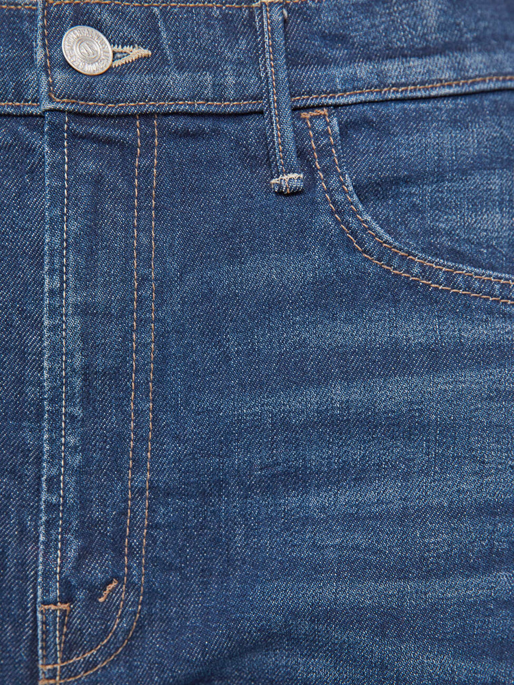 Swatch view of a woman in a dark blue jeans designed to sit lower on the hips with a wide, full barrel leg, zip fly, a long 31-inch inseam and a clean hem.