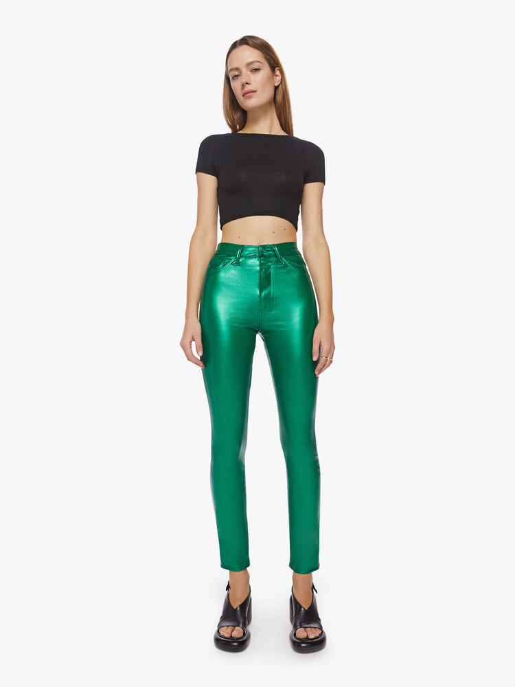 Front view of a woman super high-waisted  faux leather green skinny-leg pants with a 31-inch inseam and a clean hem.