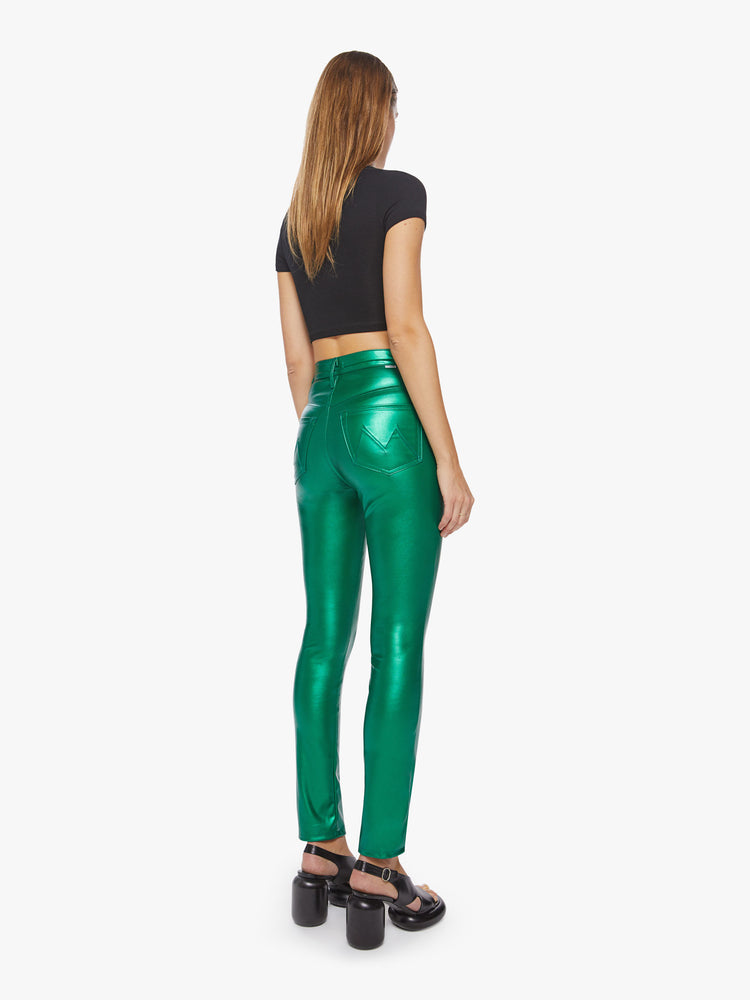 Back view of a woman super high-waisted faux leather green skinny-leg pants with a 31-inch inseam and a clean hem.