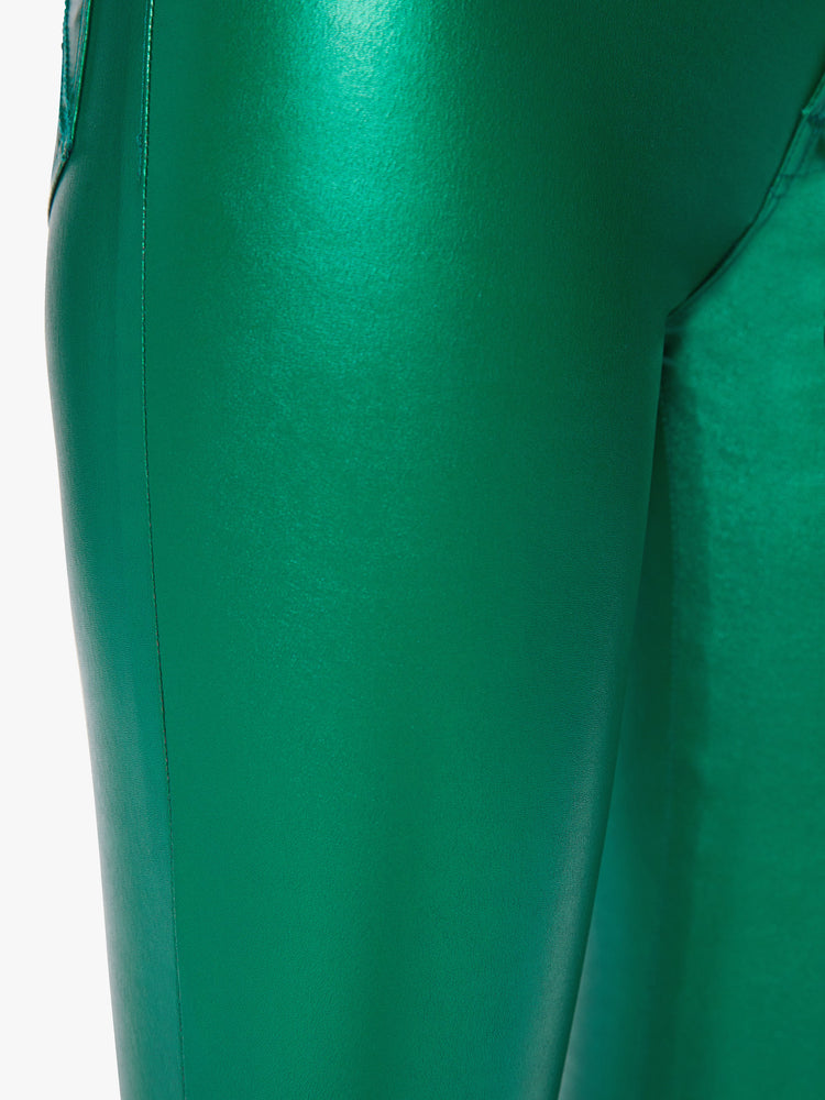 Close up leg view of a woman super high-waisted faux leather green skinny-leg pants with a 31-inch inseam and a clean hem.