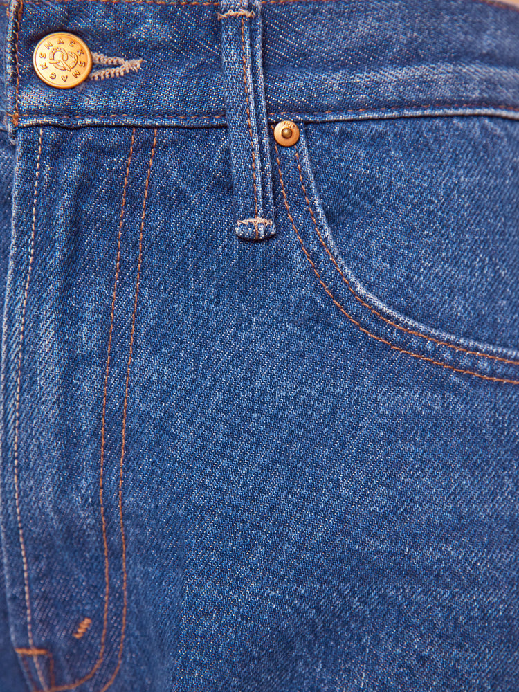 Swatch view of woman in a mid blue super high rise jeans have a zip fly, loose wide leg with a curved outer seam and a long inseam with a clean hem.